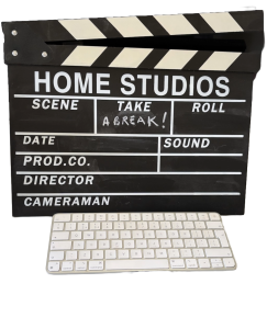 Clapperboard with Take A Break written on it behind a keyboard
