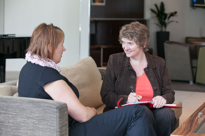 Agency copywriter Alison Harmer with a client on a sofa to illustrate building client relationships