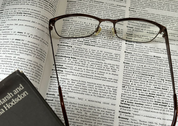 Marketing copywriter, reading glasses on top of newspaper