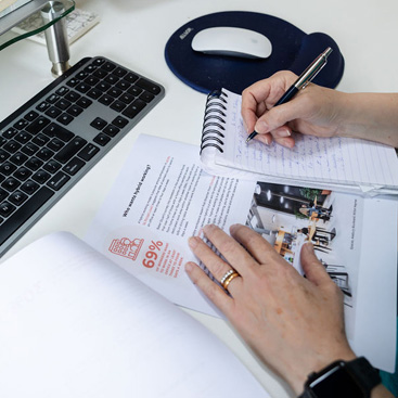 Proofreader's hands holding a page proof