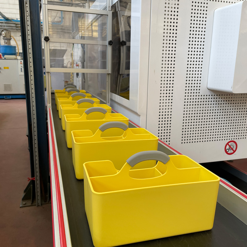 A Hotbox yellow caddy on a production line to illustrate manufacturing as one of Alison Harmer's copywriting specialisms.